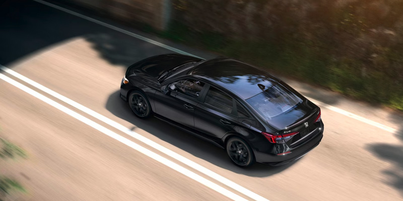 top shot of a black 2025 Honda Civic driving down a road