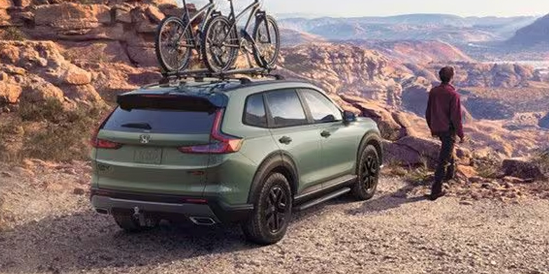 Green 2026 Honda CR-V Hybrid with Bikes and Roof Rack ready for tough terrain